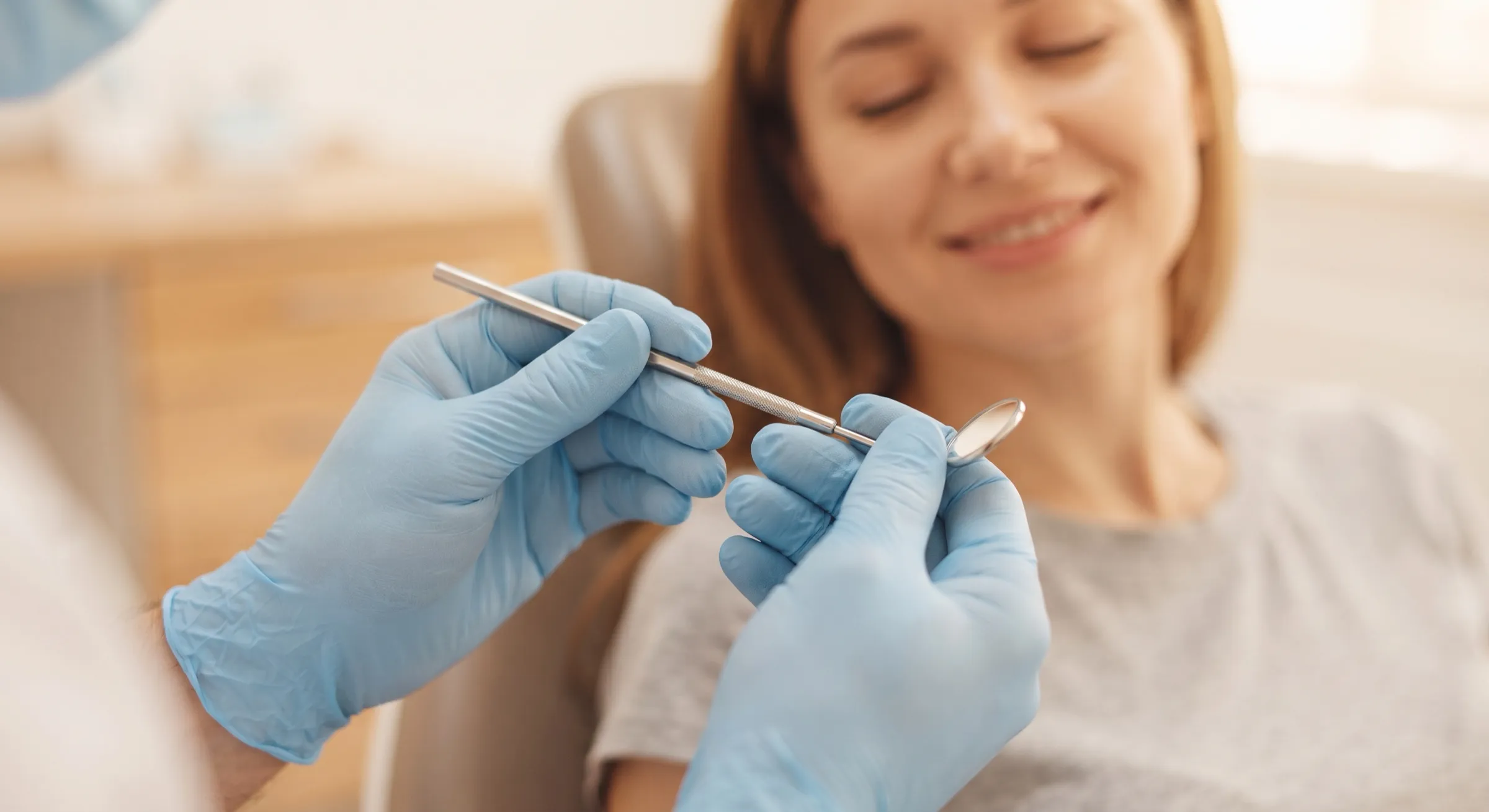 A smiling patient relaxing in the dental chair during a gentle check-up